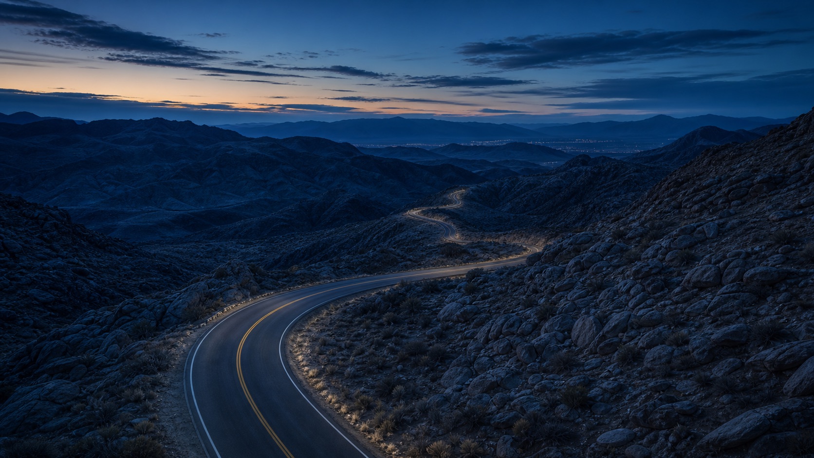 Winding road through Nevada mountains at blue hour